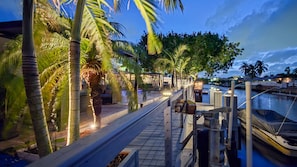 A waterfront walkway with palm trees, a dock, and a marina. - Luxury Fort Lauderdale Waterfront Home • Heated Pool • Game Room •  Park (Fort Lauderdale)