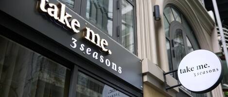 A building with a sign that reads 'take me. 3 seasons.'