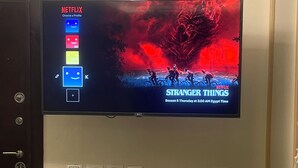 A television mounted on a wall displaying the Netflix interface with the show 'Stranger Things' Season 5. - Stylish Downtown Cairo Apartment with Balcony View & Prime Location (Cairo)