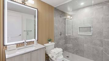 Shower, hair dryer, towels, shampoo