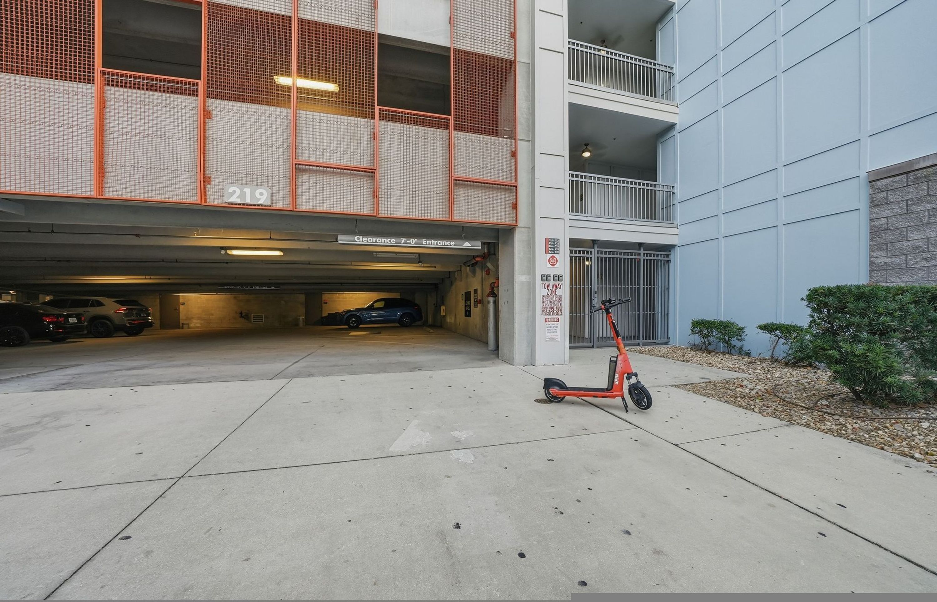 A multi-level parking garage with a clear entrance marked '219' and a sign indicating 'Clearance 7'-0' for vehicle entry.