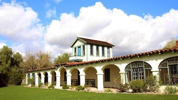 A building with a central tower, multiple arches, and a flat roof.