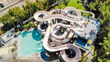 An aerial view of a water park with multiple slides and a swimming pool.