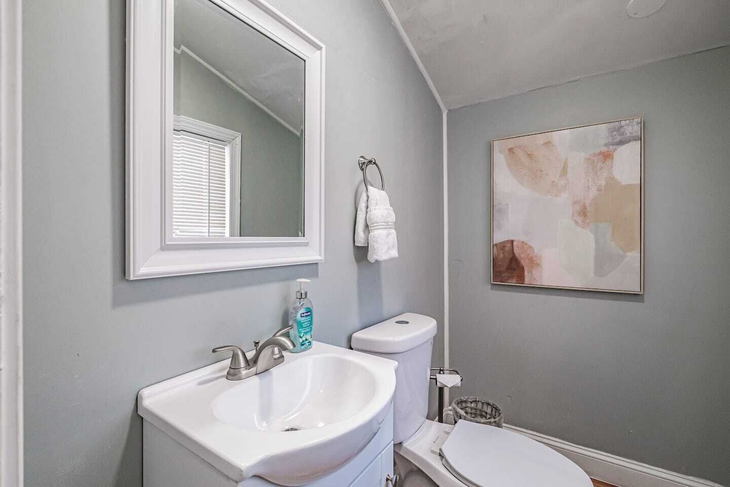 Freshen up in the convenient half bath, thoughtfully stocked with everyday essentials.
