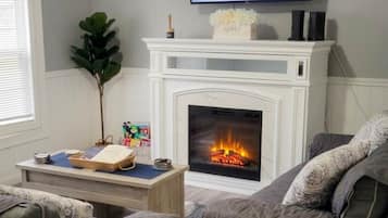 Cozy living room with TV and gas fireplace