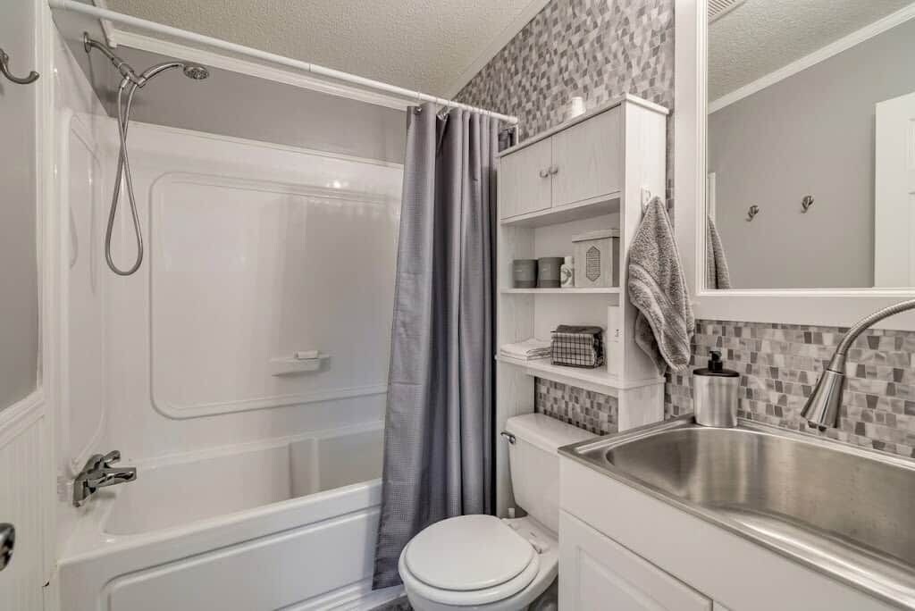 A bathroom with a bathtub, toilet, and sink.