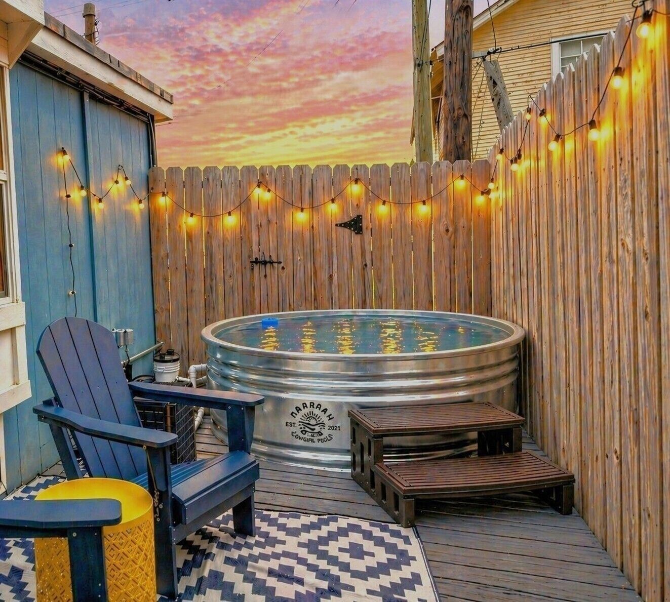 Private patio with heated/chilled pool, string lights, and cozy seating
