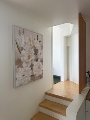 A staircase with wooden steps and a white wall.