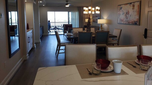 A hotel room with a dining area, a kitchen, and a balcony. - Luxurious resort stay with amazing all-inclusive amenities near Orlando Florida! (Kissimmee)