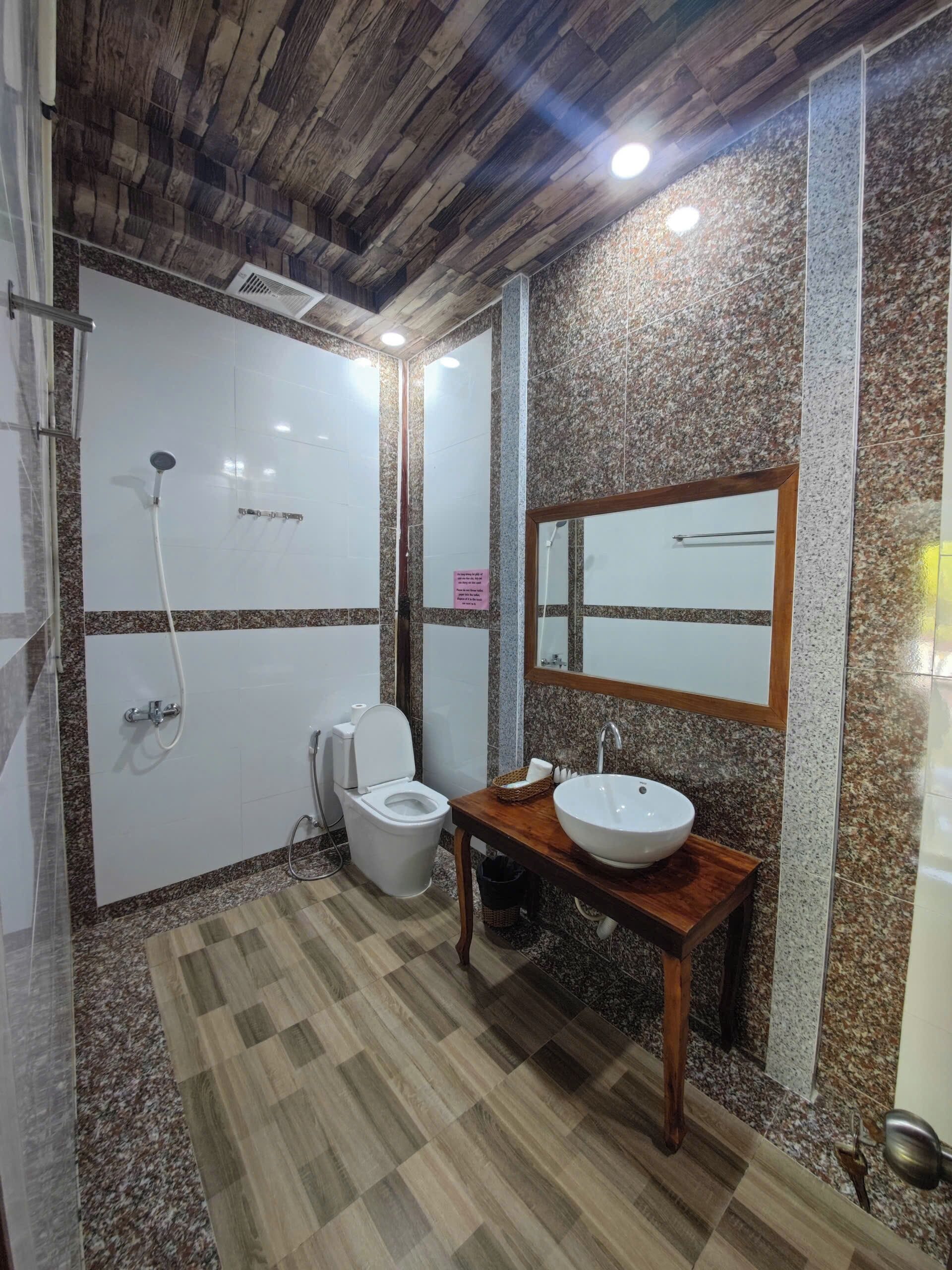 A bathroom with a shower, toilet, and sink.
