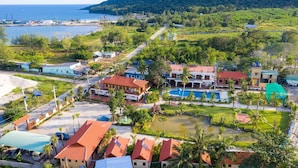 A coastal resort with multiple buildings, a swimming pool, and a beach area. - Serene Resort in Bai Vong Phu Quoc (Phu Quoc)