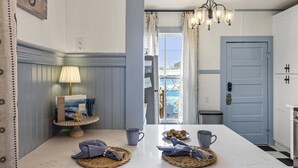 A kitchen with a white countertop, a chandelier, a door, and a view of the outdoors. - Backyard Retreat w Pool • Steps to Beach! • 2 Kings + Bikes (Galveston)
