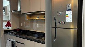 A modern kitchen with stainless steel appliances, a gas stove, and a built-in oven. - 3-bedroom condo with beautiful views, pool, gym & gardens at Salto del Monday (Franco)