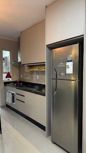 A modern kitchen with stainless steel appliances, a gas stove, and a built-in oven.