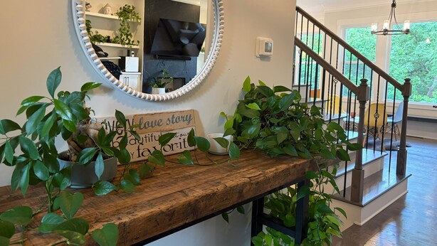 A wooden bench with a mirror and a sign, a staircase, and a view of the outdoors. - Game Room Luxury Home @ Battery Chef Kitchen Deck (Marietta)