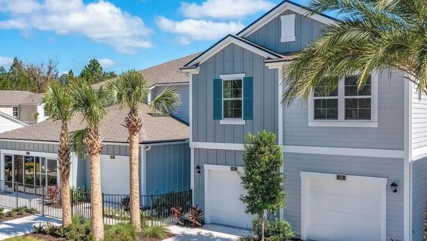 A residential building with a garage, a covered porch, and palm trees. - New St. Augustine Getaway Near Beaches, Golf & Downtown Adventures (St. Augustine)