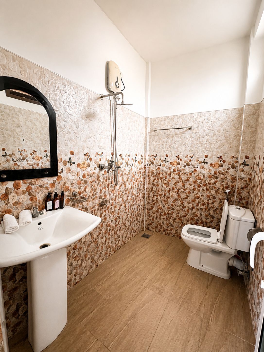 A bathroom with a sink, toilet, and shower.