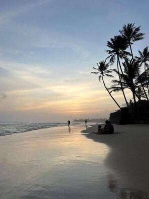 On the beach, white sand, sun-loungers, beach umbrellas
