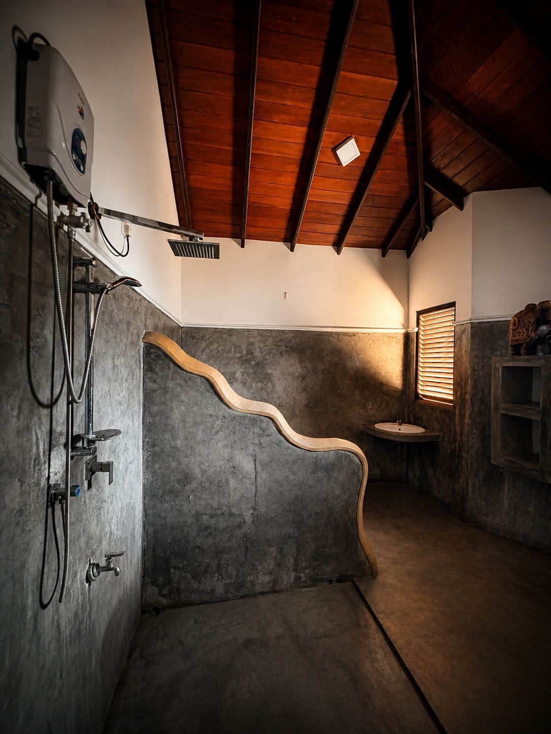 A rustic bathroom with a shower, a sink, and a wooden ceiling beam.