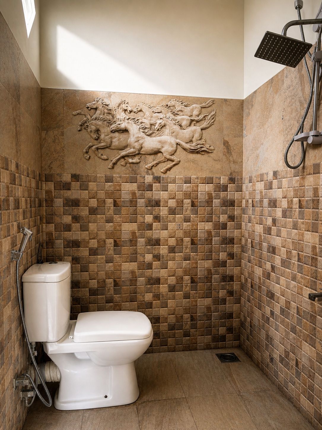 A bathroom with a mosaic wall, a toilet, and a shower.