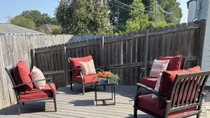 A wooden deck with outdoor furniture, a metal table, and a wooden fence. - LSU BOUND! We are minutes from everything! (Baton Rouge)