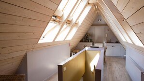 A sloped ceiling with skylights, a kitchenette, and a partition wall. - The Abiente Rooms (Bruges)