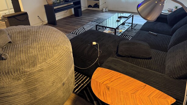 A living room with a sofa, a coffee table, a TV, and a lamp. - West LA Wold Cup Hideaway (Los Angeles)