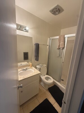 A bathroom with a sink, toilet, and shower. - West LA Wold Cup Hideaway (Los Angeles)