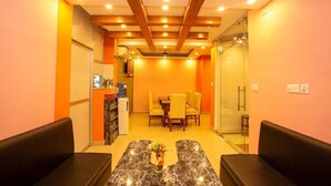 A reception area with a reception desk, seating area, and a glass partition. - Hotel Ram Janaki (Janakpur)
