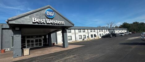 Un hotel Best Western con entrada cubierta, estacionamiento y una hilera de habitaciones.