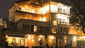 A multi-story building with outdoor seating and a spa sign. - Ramana on the Ganges (Tapovan, Rishikesh)