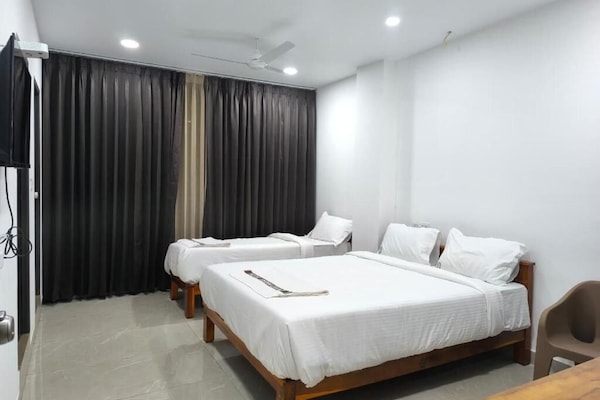 Deluxe Triple Room, City View | Desk, laptop workspace, blackout drapes, soundproofing