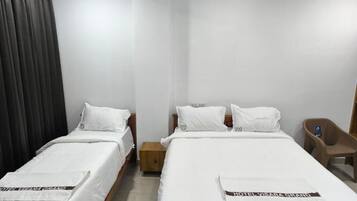 Deluxe Triple Room, City View | Desk, laptop workspace, blackout curtains, soundproofing