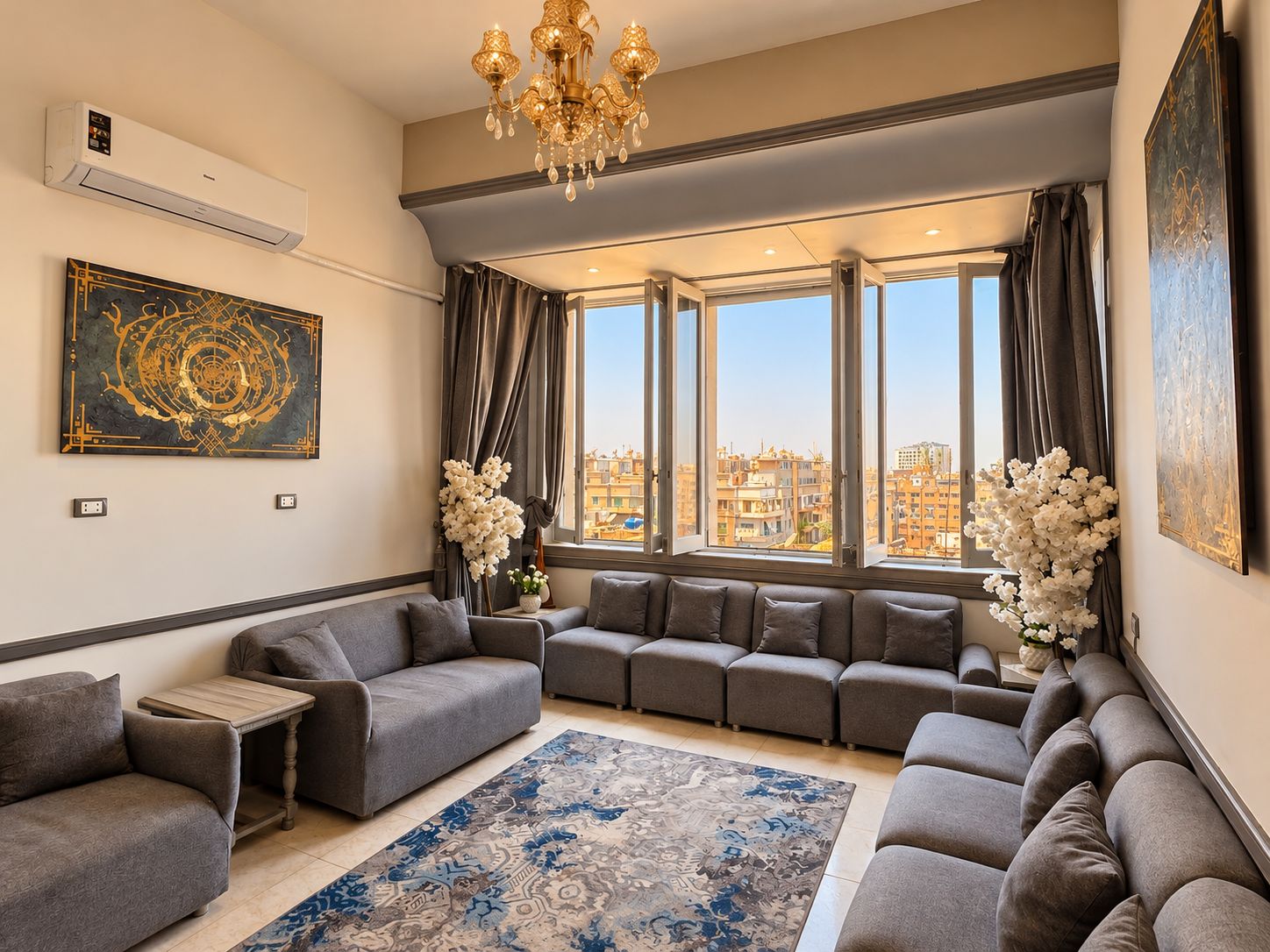 A modern living room with a sectional sofa, a small table, and a large window with curtains.
