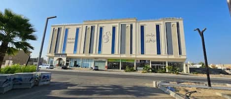 A modern building with a symmetrical facade, large windows, and a central entrance.