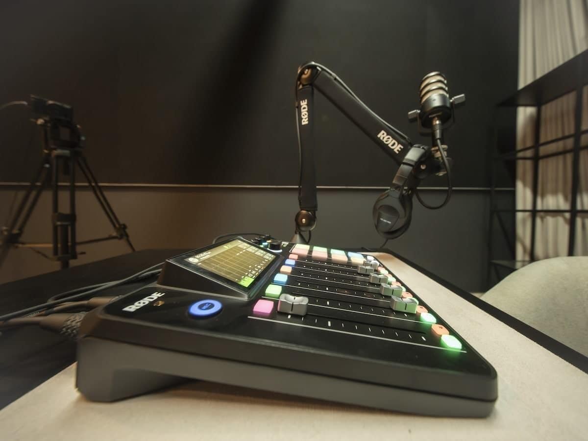A professional audio mixing console with a microphone arm and a control panel with various buttons and sliders.