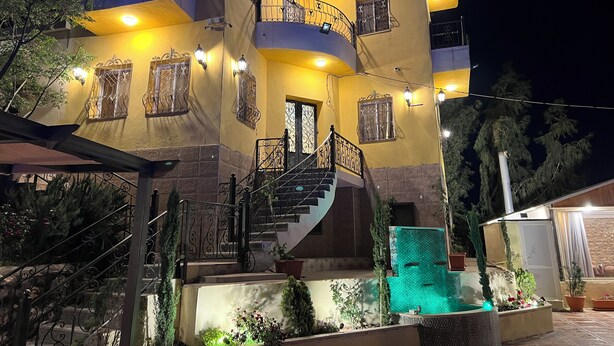 A multi-story building with balconies, a staircase, and a pool area. - Secluded Hilltop Villa Near Ancient Jarash — Privacy, Views & Pure Tranquility (Jerash)