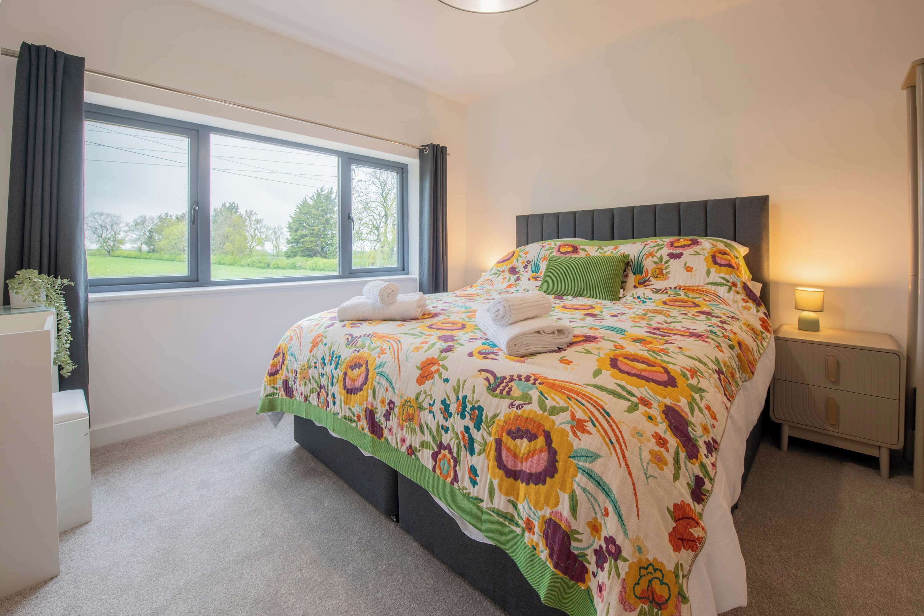 Wake up to countryside views and natural light pouring into this bright and spacious bedroom retreat.