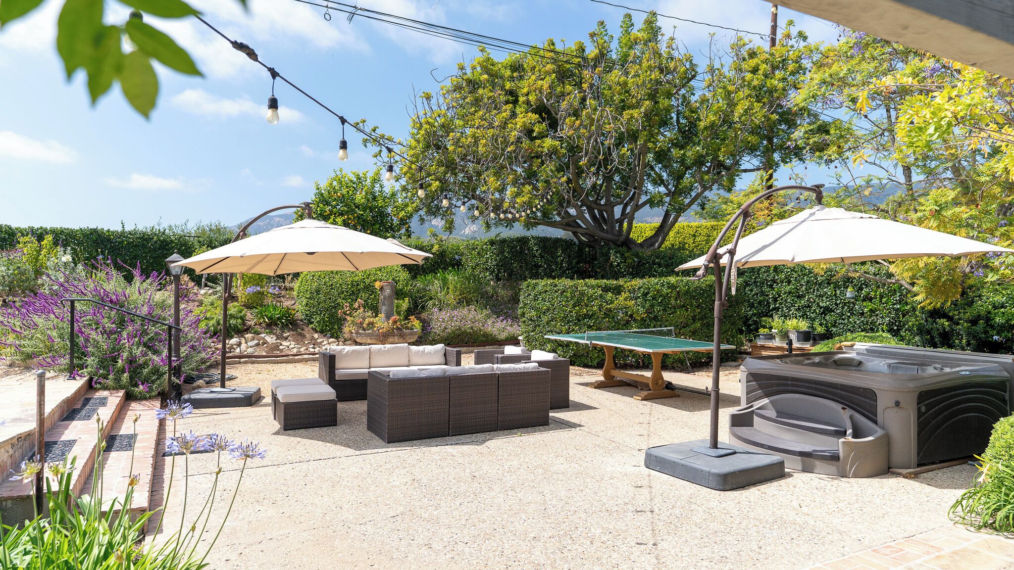 Une terrasse extérieure équipée d’une table de billard, d’un coin salon et d’un barbecue.