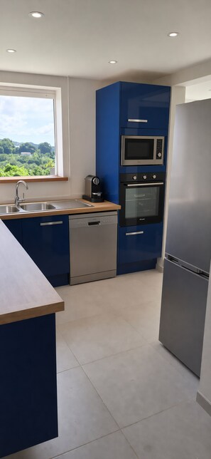 Eine moderne Küche mit eingebautem Geschirrspüler, Backofen und Mikrowelle.