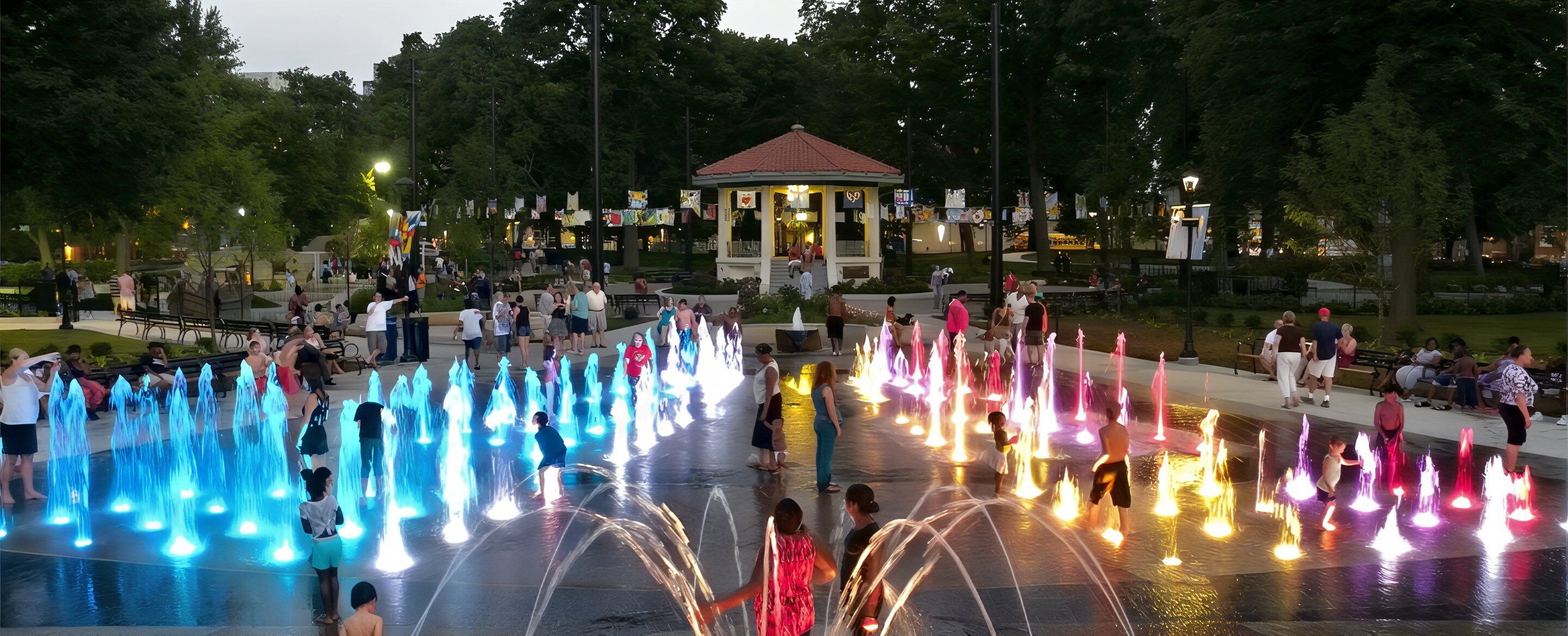 A public park with a fountain display and a gazebo.