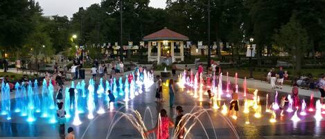 A public park with a fountain display and a gazebo.