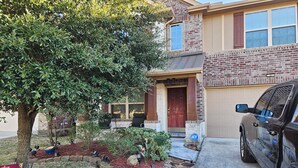 A residential house with a brick exterior, a garage, and a driveway. - Peaceful Retreat for Travel Nurses & Corporate Stays (Spring)