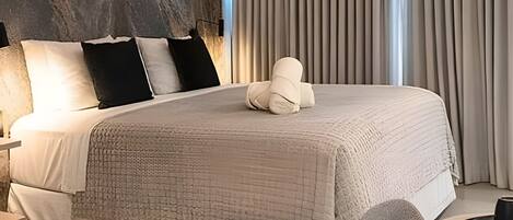 A neatly made bed with a textured blanket, a pillow, and a decorative item on the bed.
