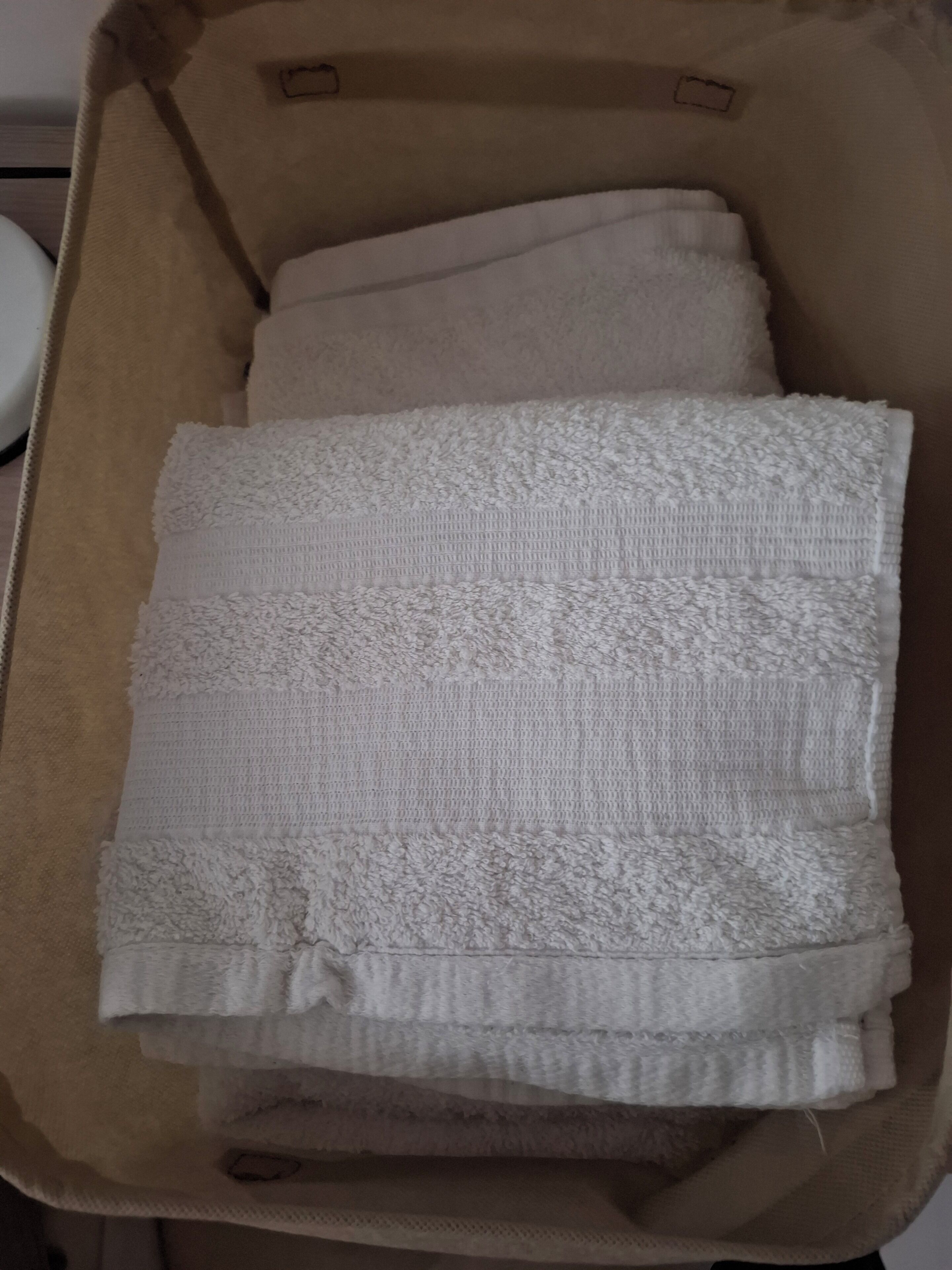 A suitcase with a white textured fabric inside.