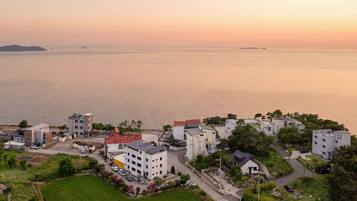 Un quartier résidentiel en bord de mer, avec des immeubles modernes, un port de plaisance et une vue sur la mer.