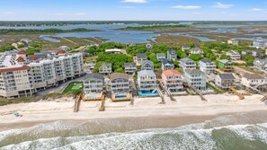 A coastal residential area with beachfront properties, including multi-story buildings and houses with direct beach access. - Great Life @ NTB Ocean View Coastal Retreat (North Topsail Beach)