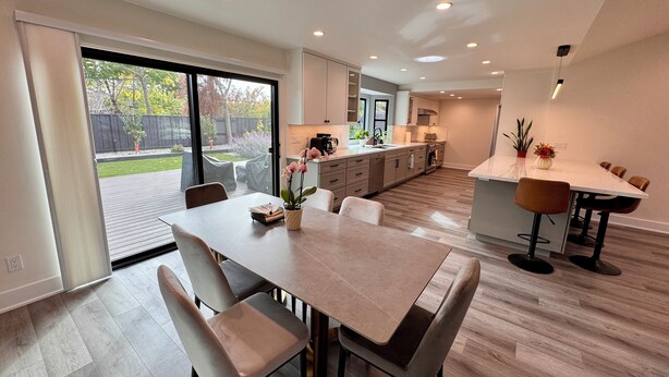 A modern kitchen with a dining area, large windows, and a view of the backyard. - New, Quiet, Modern Comfort 3-bedroom house in tranquil Cupertino (Cupertino)