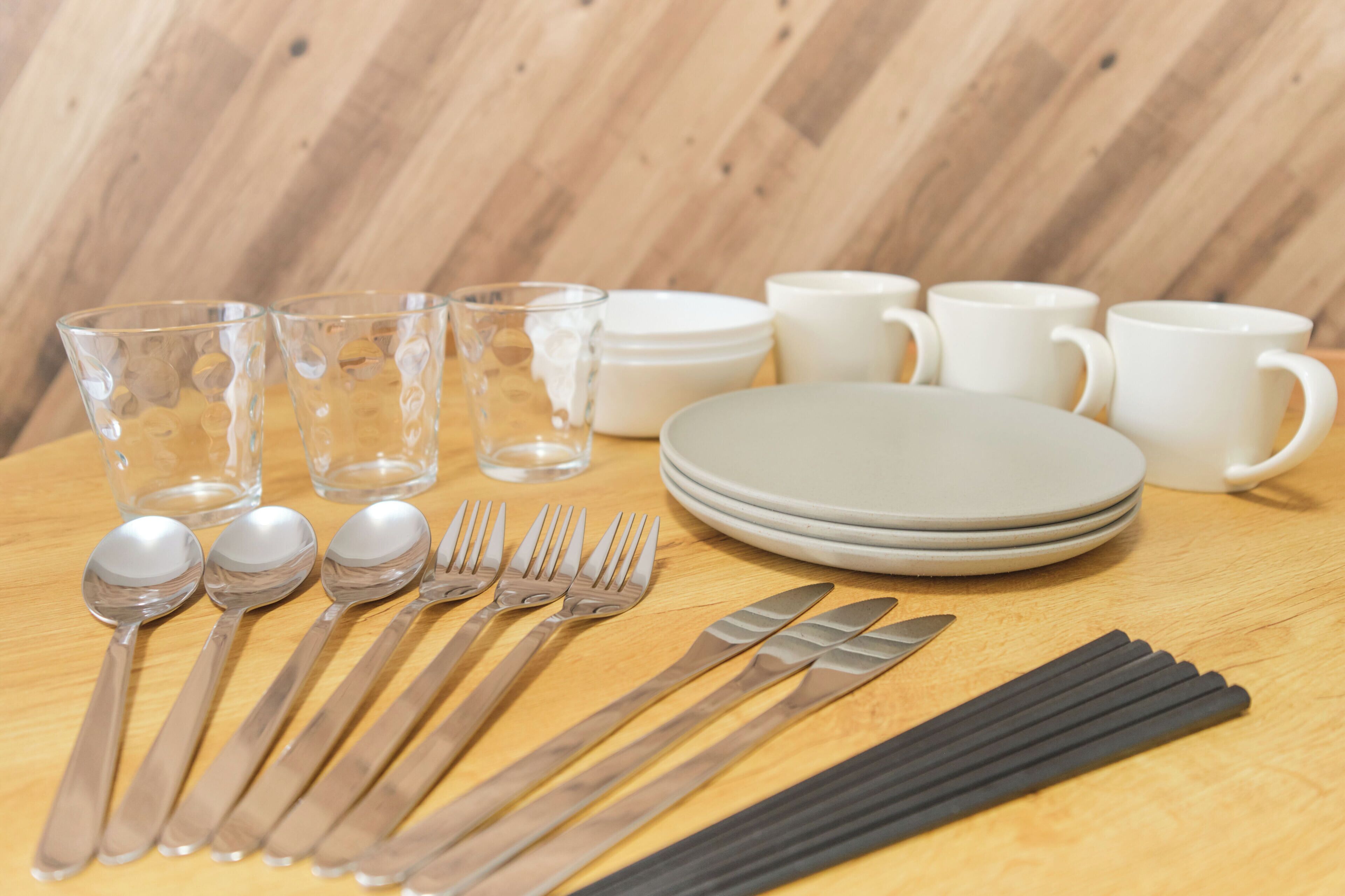 A table set with clear glassware, white plates, and cutlery.