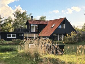 A modern two-story house with a sloped roof, large windows, and a surrounding natural landscape. - "Arendine" - 250m from the sea by Interhome (Ørsted)